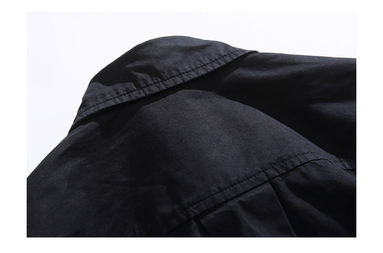 Close-up of a black collared garment showing the collar and back yoke seams.