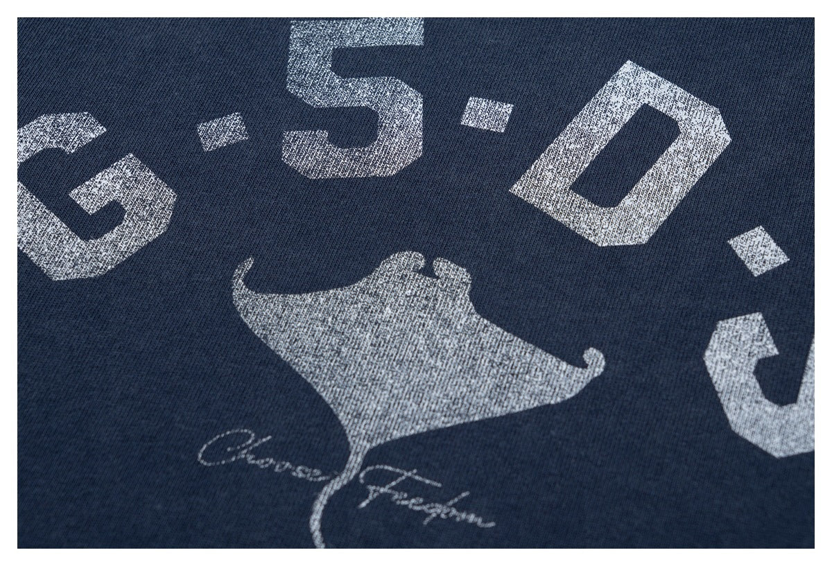 Close-up of the shirt's distressed white lettering and manta ray graphic.