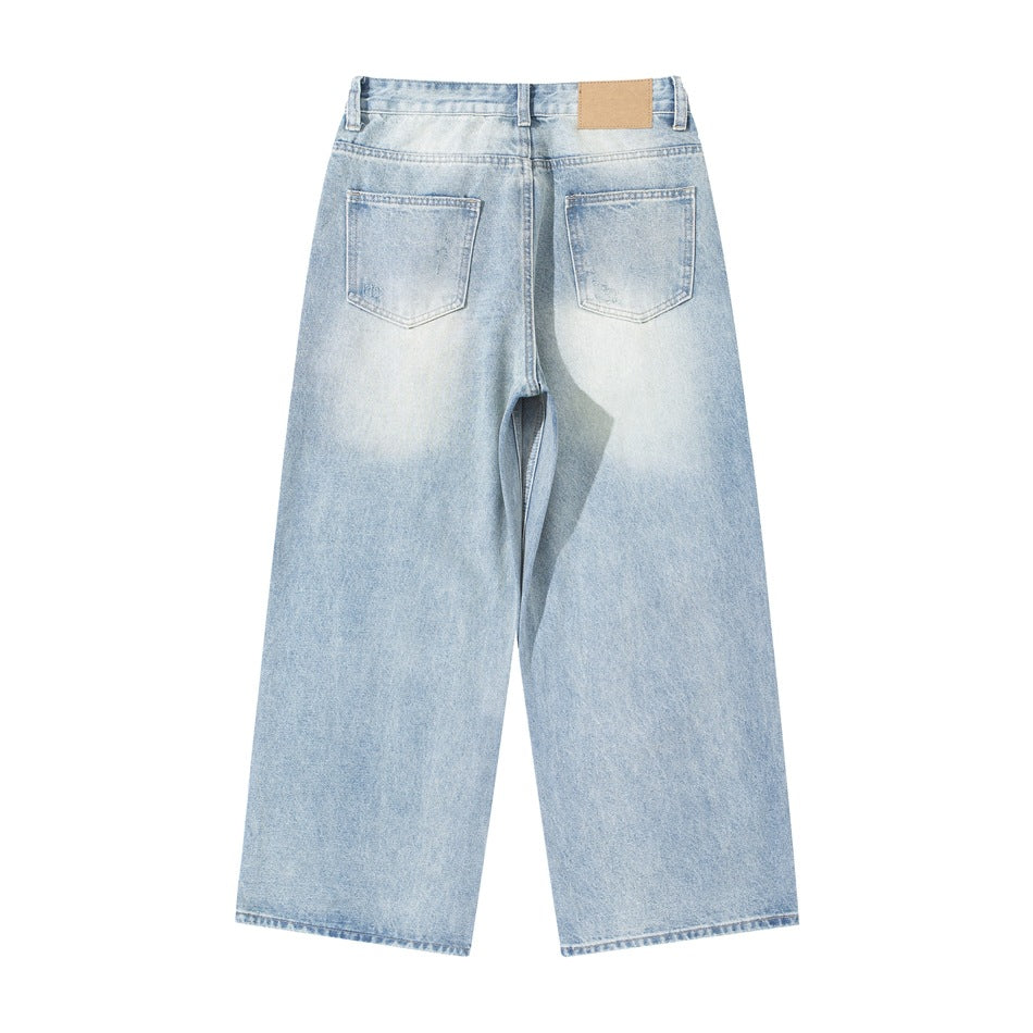 Back of light blue washed wide-leg jeans with two patch pockets and a tan waistband patch
