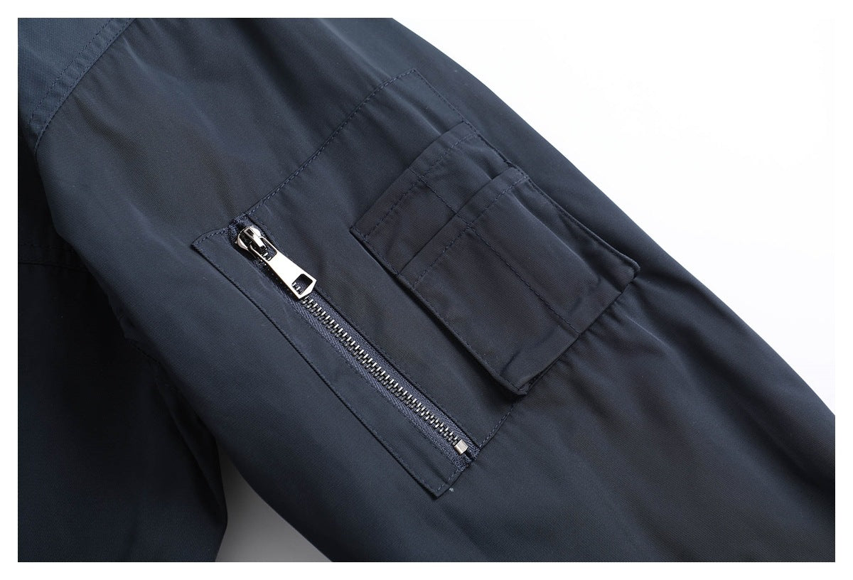 Close-up of a dark navy sleeve with a zippered utility pocket and flap pocket.