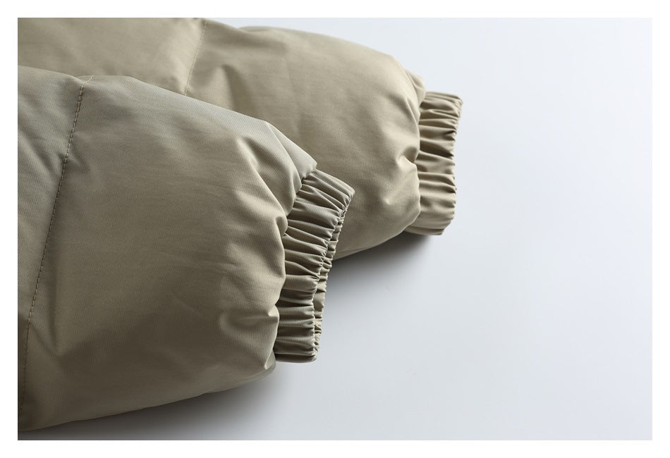 Close-up of a taupe jacket sleeve showing gathered elastic cuffs and stitching.