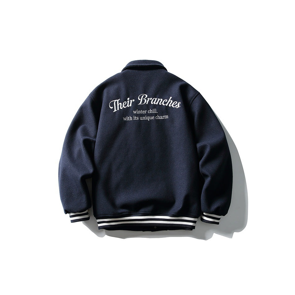 Back of navy varsity-style jacket with large white embroidered script lettering and striped cuffs and hem