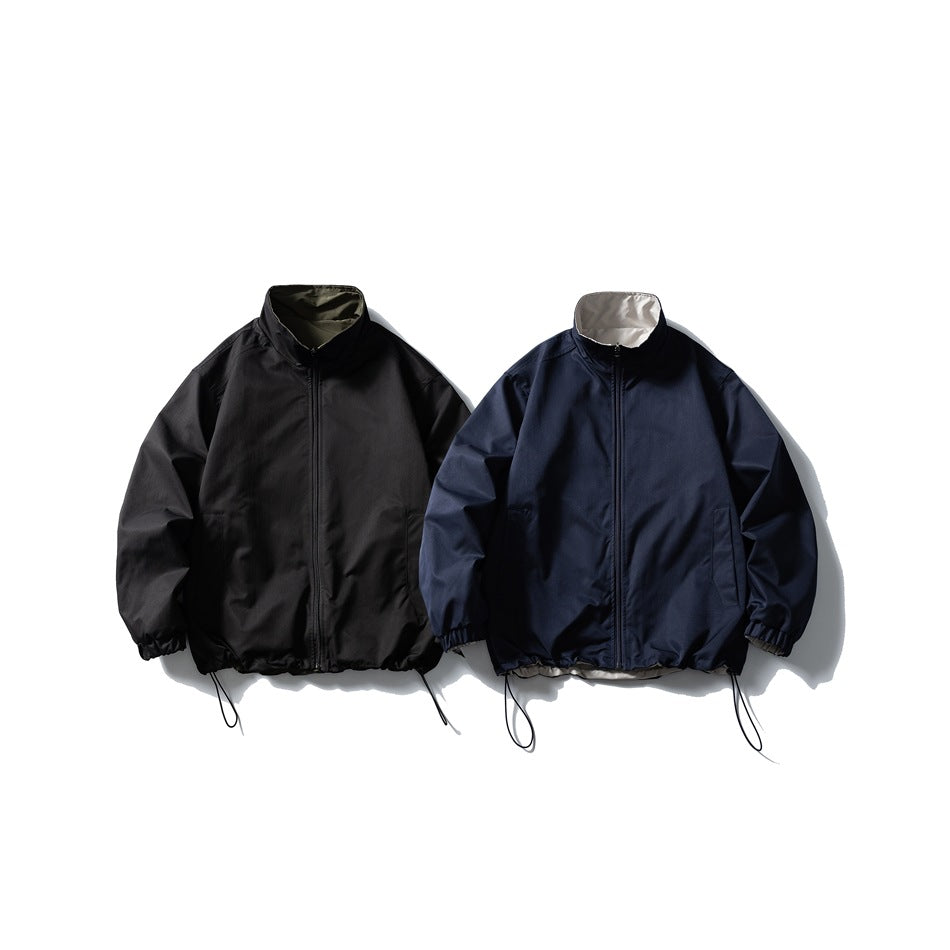 Front views of two stand-collar jackets, one black and one navy, with full zippers and drawcord hems.