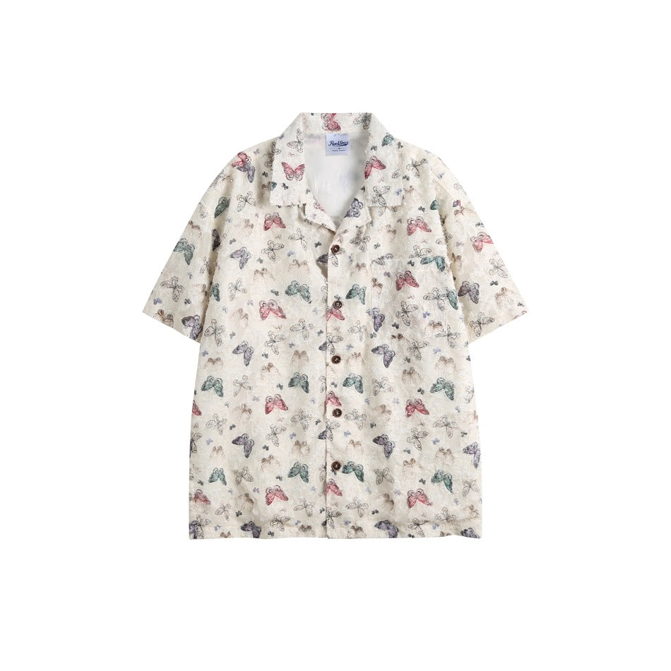 Off-white short-sleeve camp-collar shirt with multicolor butterfly print, brown buttons and chest pocket, flat front view