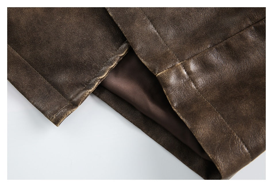 Close-up of a dark brown jacket hem with a folded edge and brown lining.