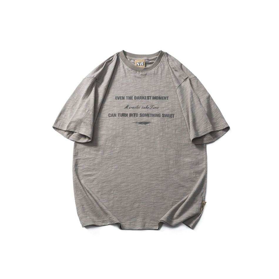 Gray short-sleeve crew-neck T-shirt with tonal chest text print, flat lay front view