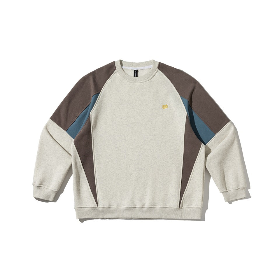 Light gray crewneck sweatshirt with brown and blue colorblock raglan sleeves and small yellow chest logo, flat lay