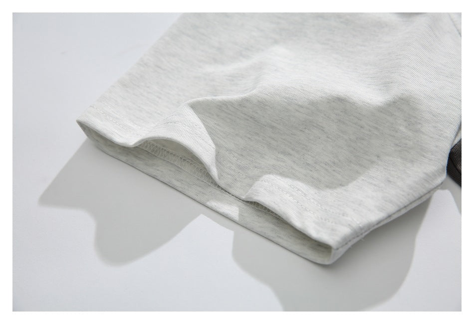 Close-up of the light heather-gray sleeve cuff and its stitching.