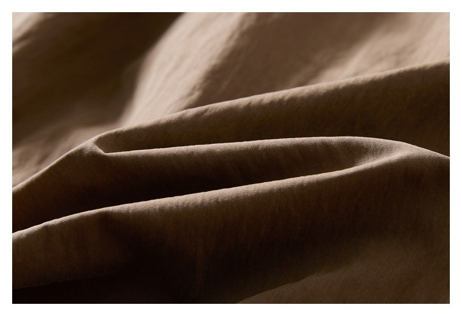 Close-up of folded brown fabric showing its surface texture.