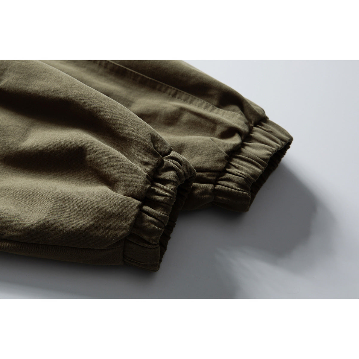 Close-up of the olive jacket's gathered elastic cuffs.