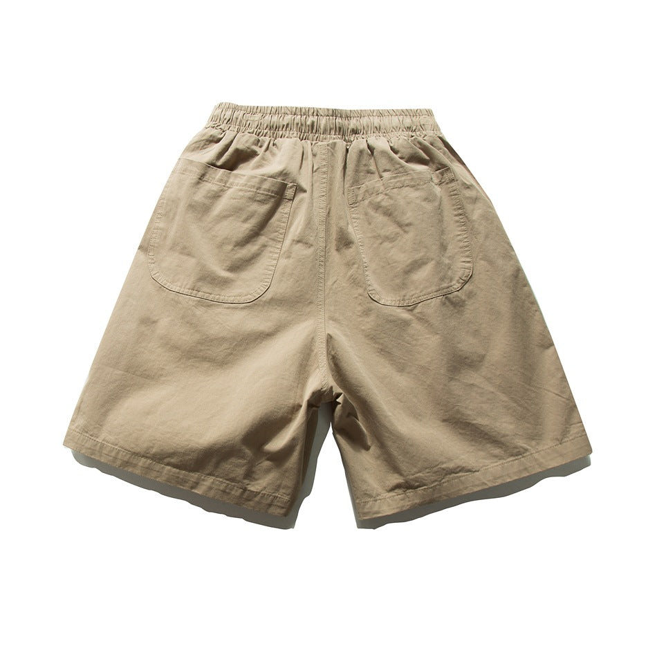 Back view of tan shorts with an elastic waistband and two large patch pockets.