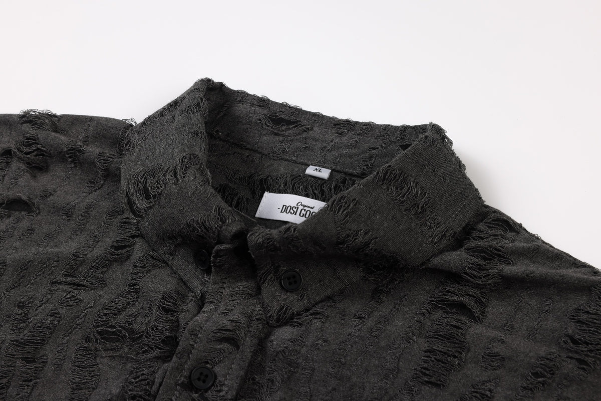 Close-up of the charcoal shirt collar, inner labels, and black buttons on its distressed striped front.