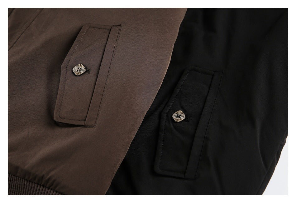 Close-up of flap pockets with patterned buttons on brown and black jackets.