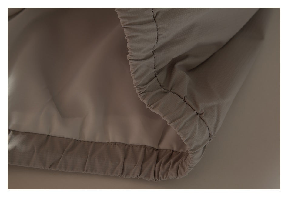 Close-up of the jacket's gathered elastic hem and seam.
