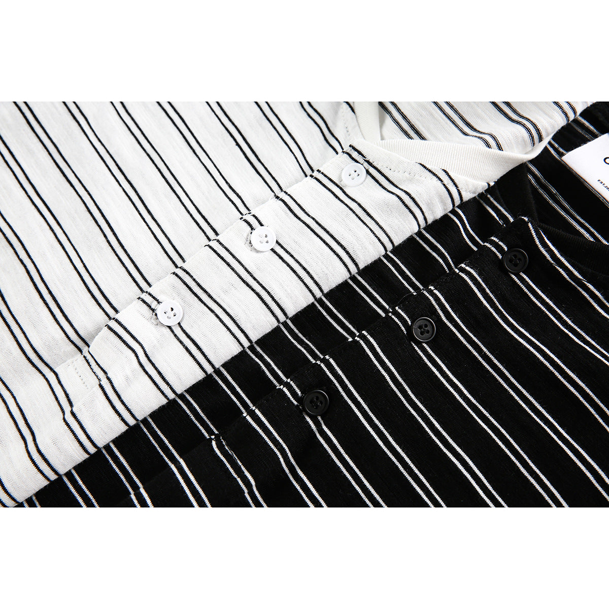Close-up of white and black striped shirt fronts with short button plackets.