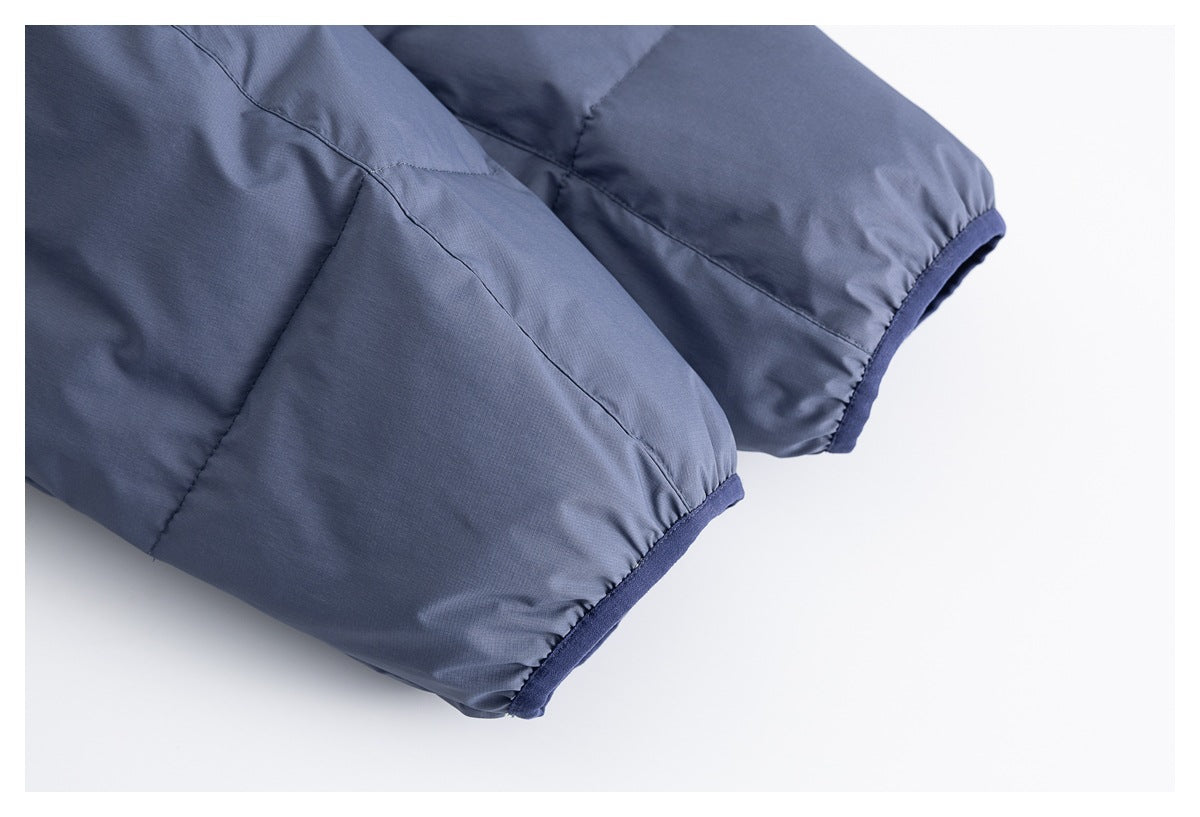 Close-up of blue-gray jacket sleeves with dark blue finished cuffs.