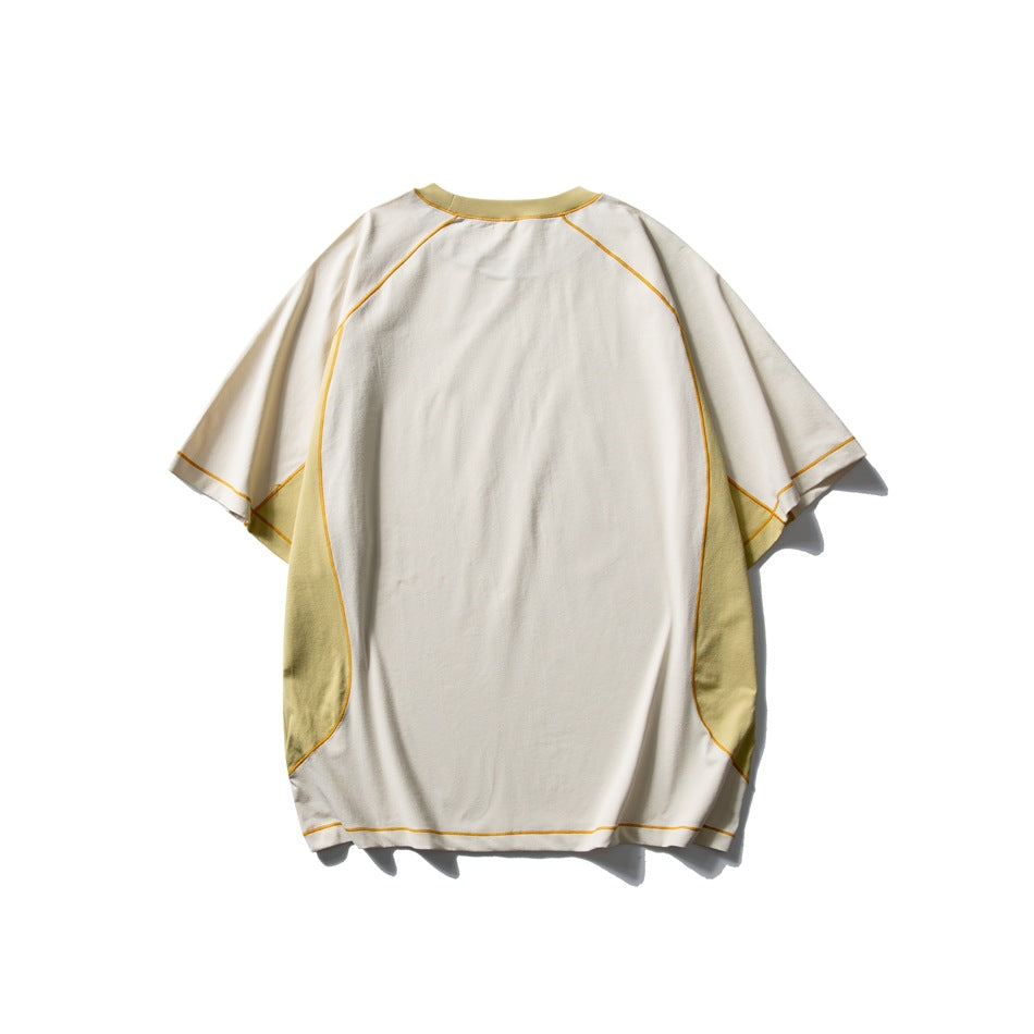 Back view of an ivory short-sleeve T-shirt with pale yellow side panels and orange contrast stitching.