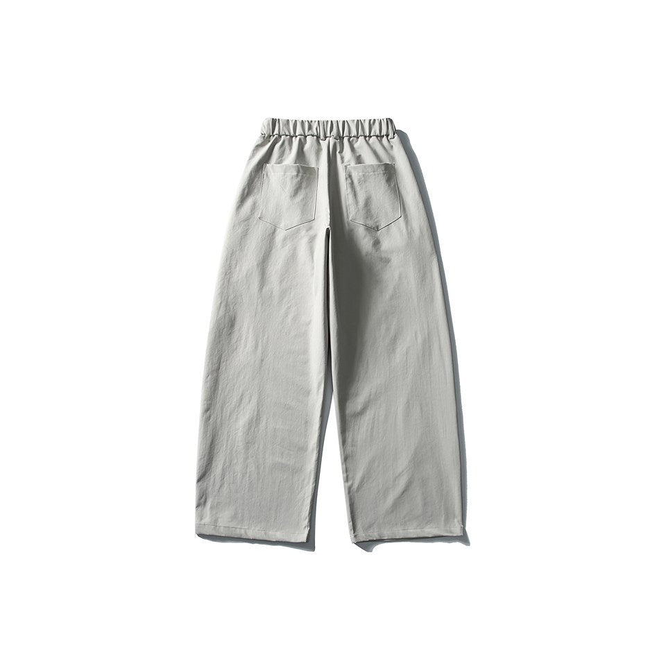 Back view of light gray wide-leg trousers with a gathered waistband and two patch pockets.