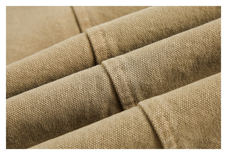 Close-up of textured tan woven fabric folded into several overlapping sections.
