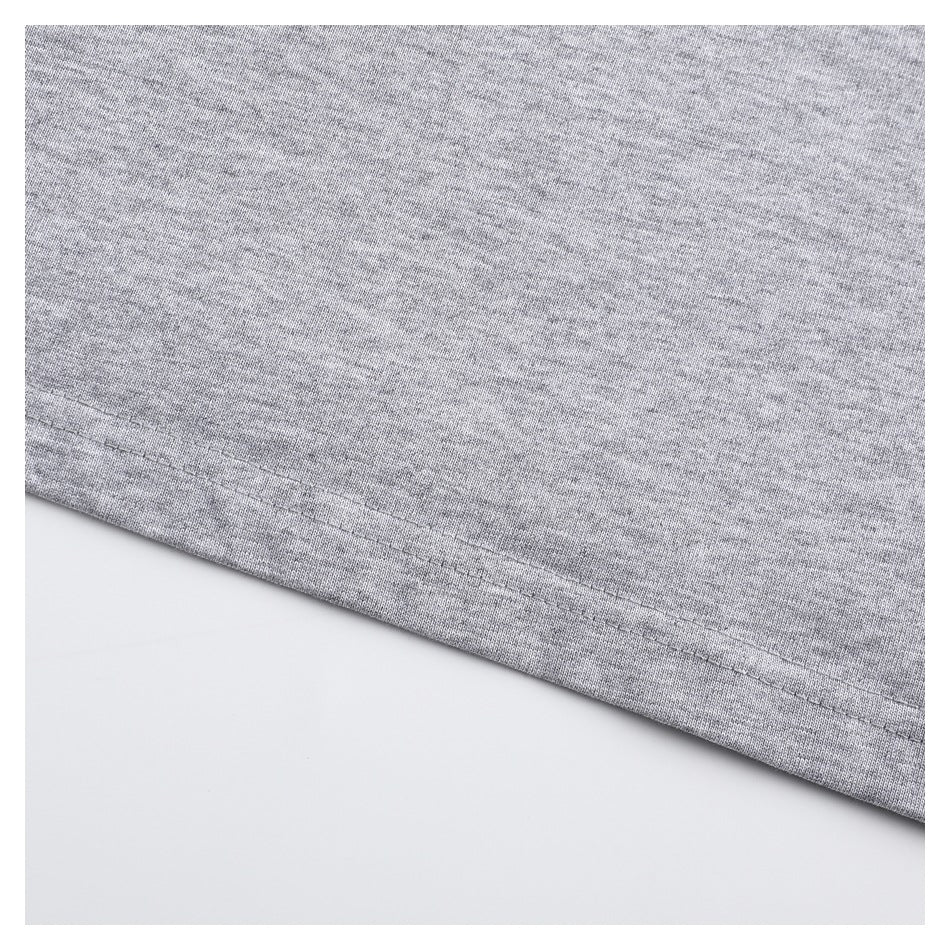 Close-up of the stitched hem on a heather gray T-shirt.