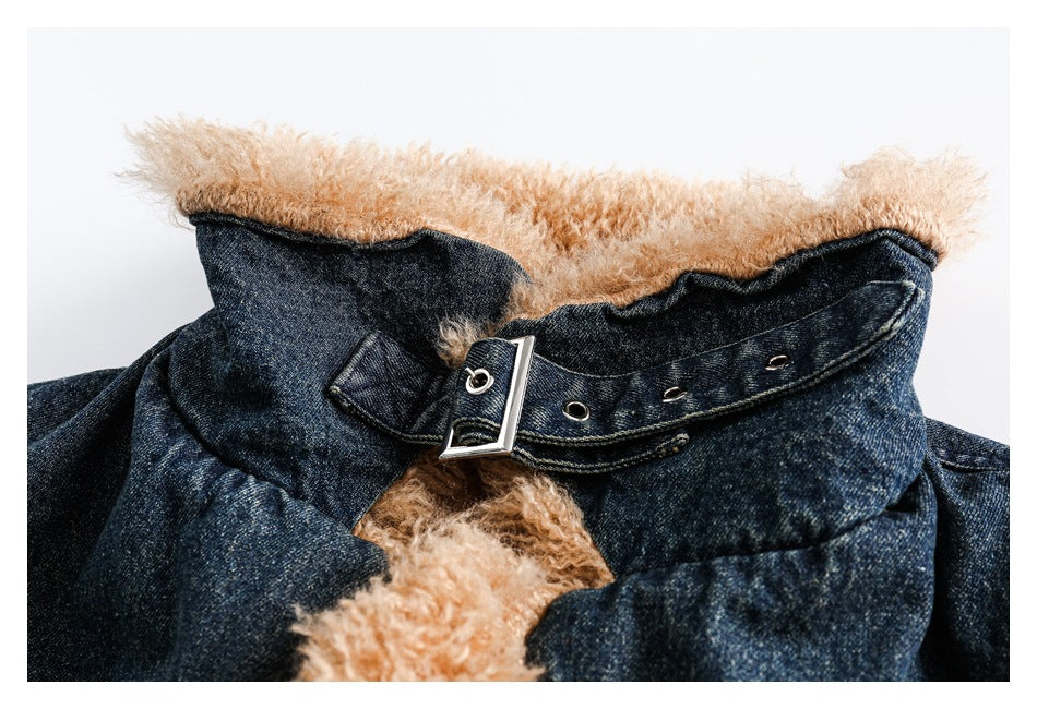 Close-up of the jacket’s tan-lined collar and denim buckle strap with metal eyelets.