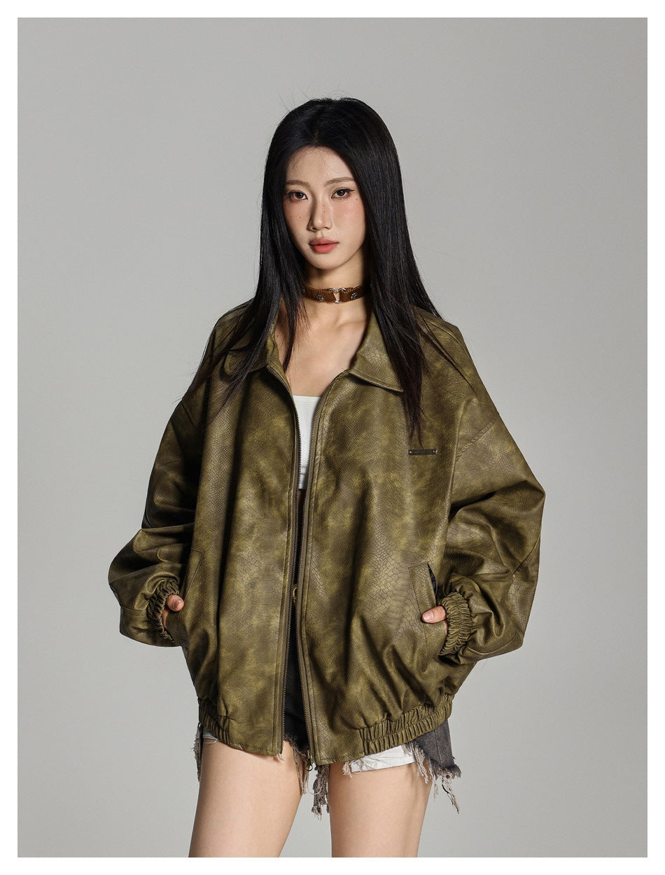 Model wearing an oversized olive textured zip jacket with a wide collar, elastic trim and side pockets.