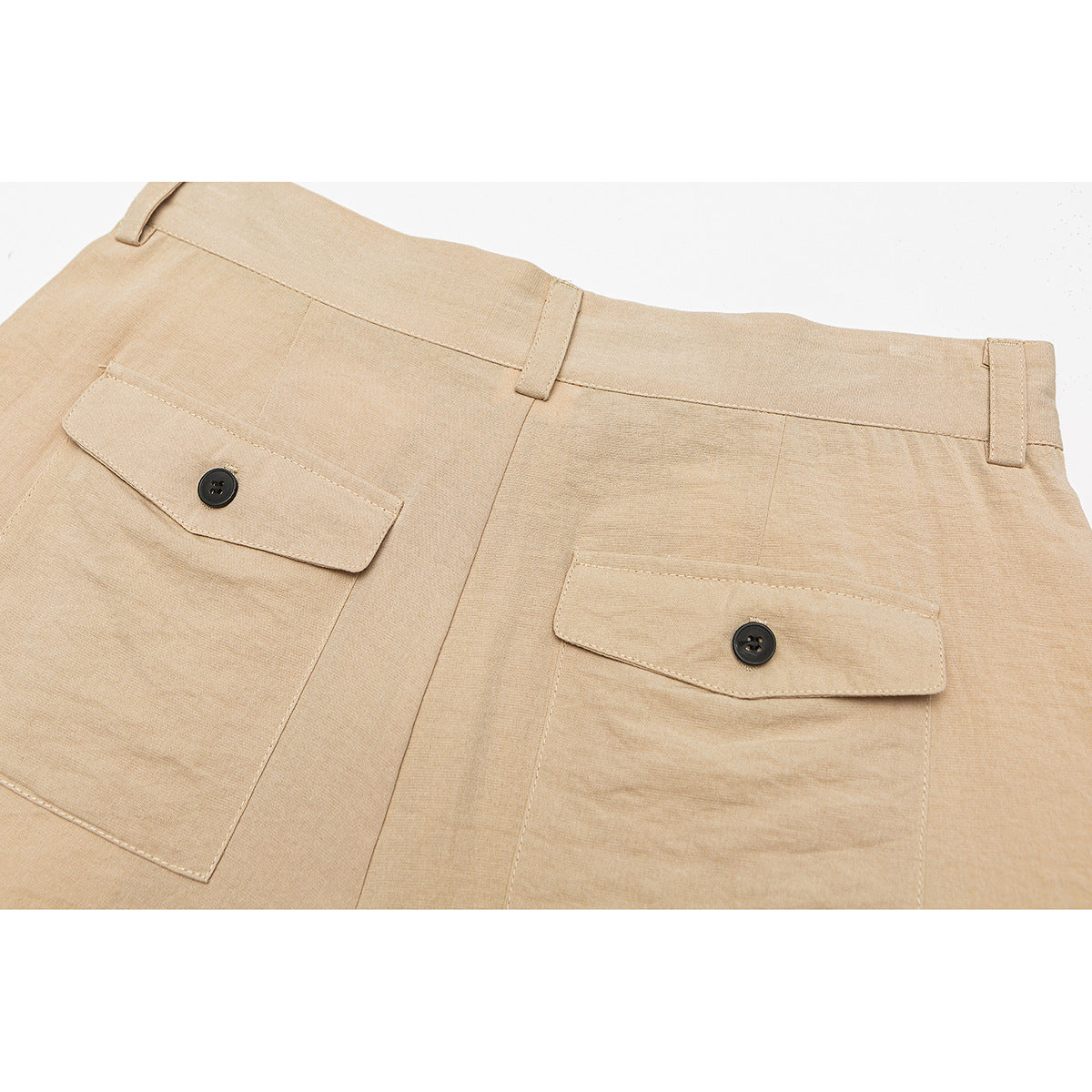 Back view of tan shorts with belt loops and two button-flap pockets.