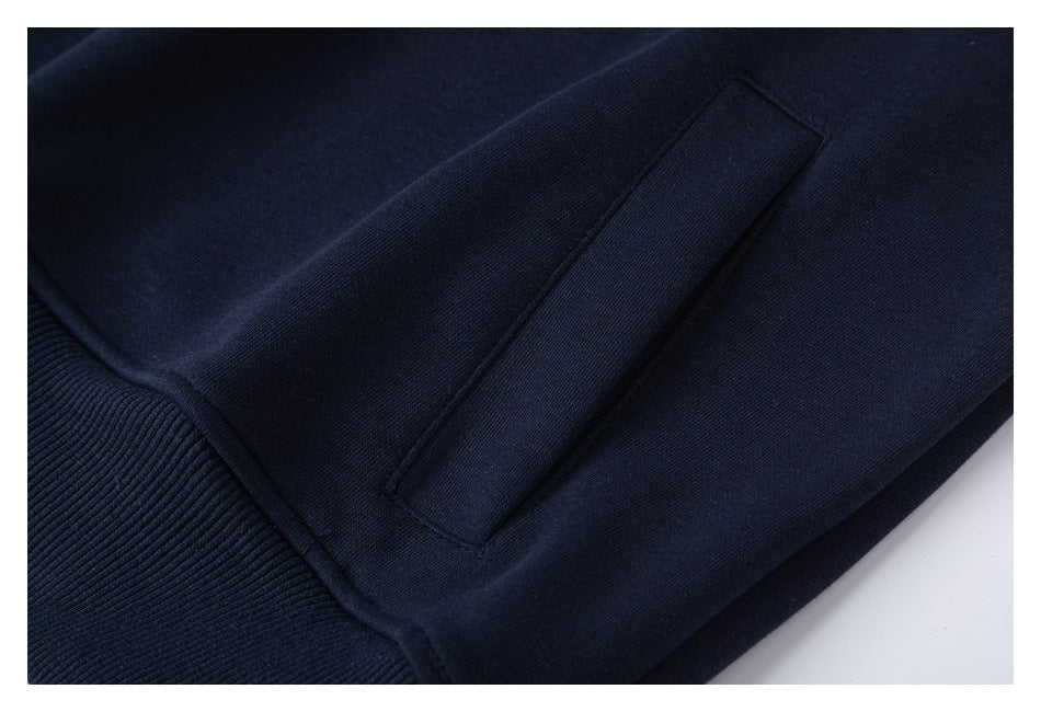 Close-up of a navy sweatshirt pocket and ribbed cuff.