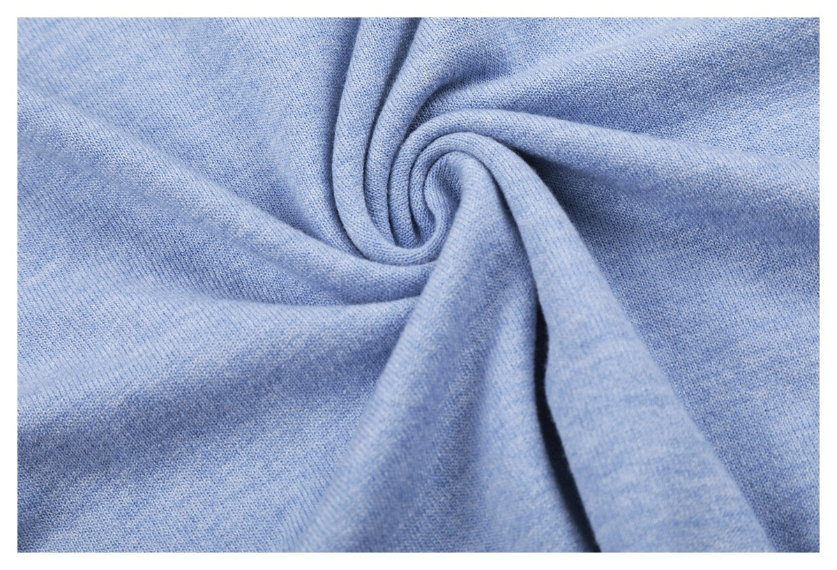 Close-up of light blue knit fabric draped into soft folds, showing its stitch texture.