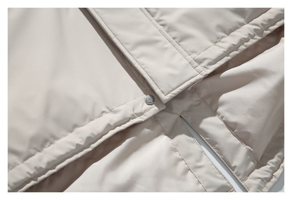 Close-up of the parka's snap-fastened front placket and stitched construction.
