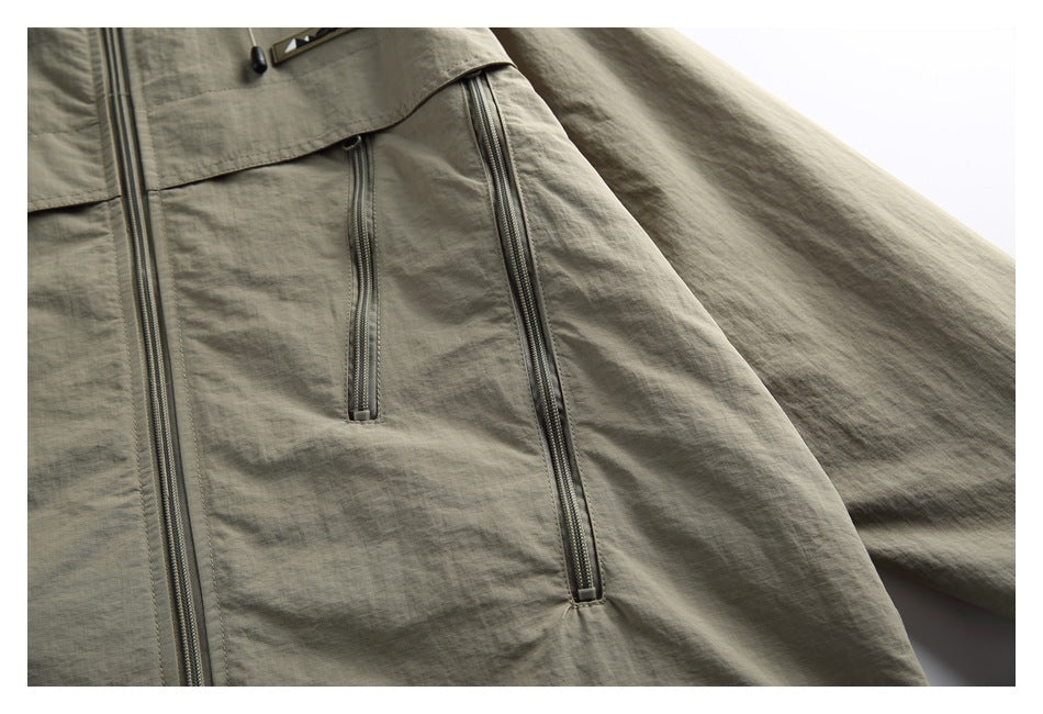 Close-up of the jacket’s front and vertical pocket zippers with part of the sleeve visible.