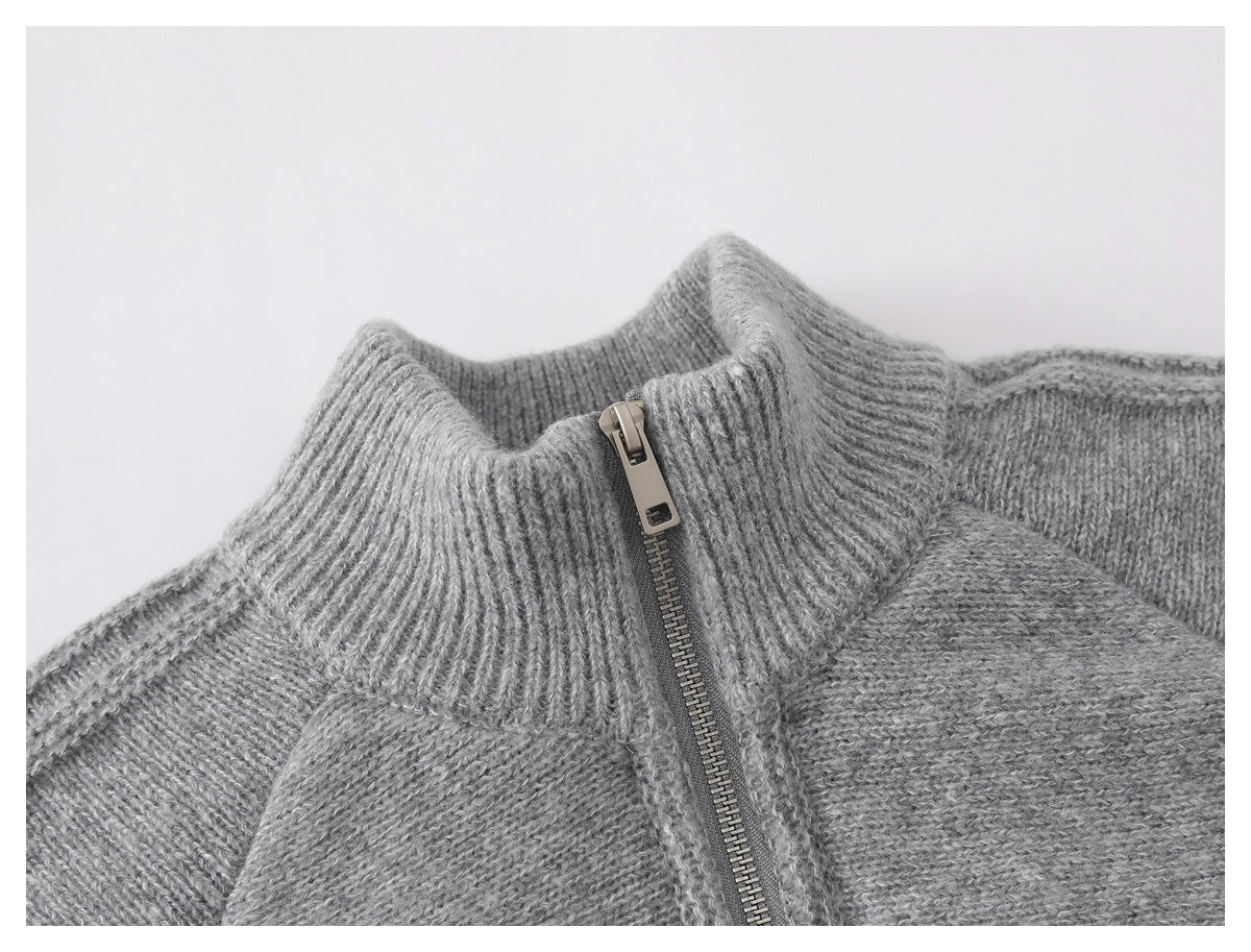 Close-up of the gray knit jacket's ribbed stand collar and metal front zipper.