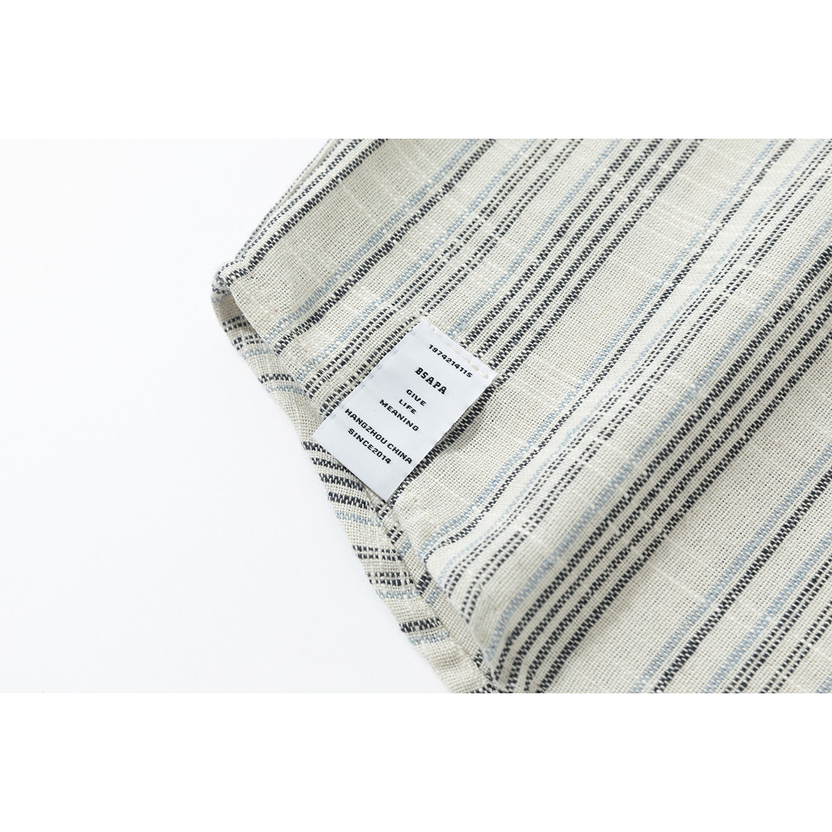 Close-up of the striped shirt's inside seam and small white label.