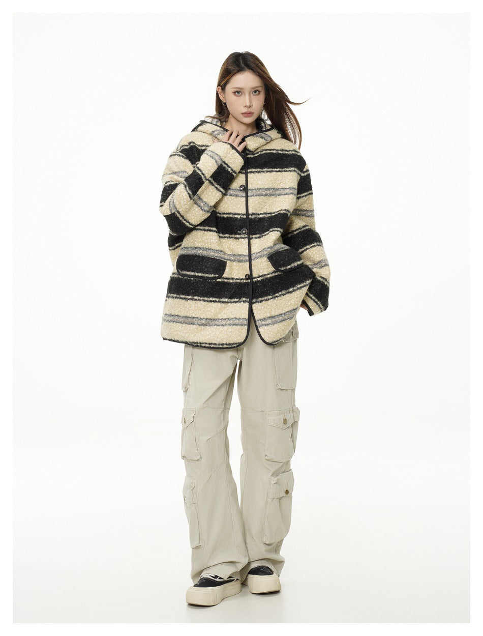 Full-length front view of a model wearing a cream, black, and gray striped hooded jacket and beige cargo pants.