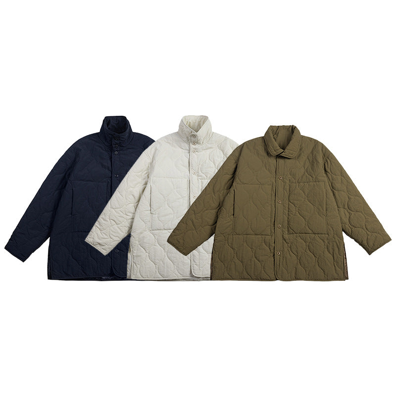 Three quilted button-front coats shown together in navy, cream, and olive brown.