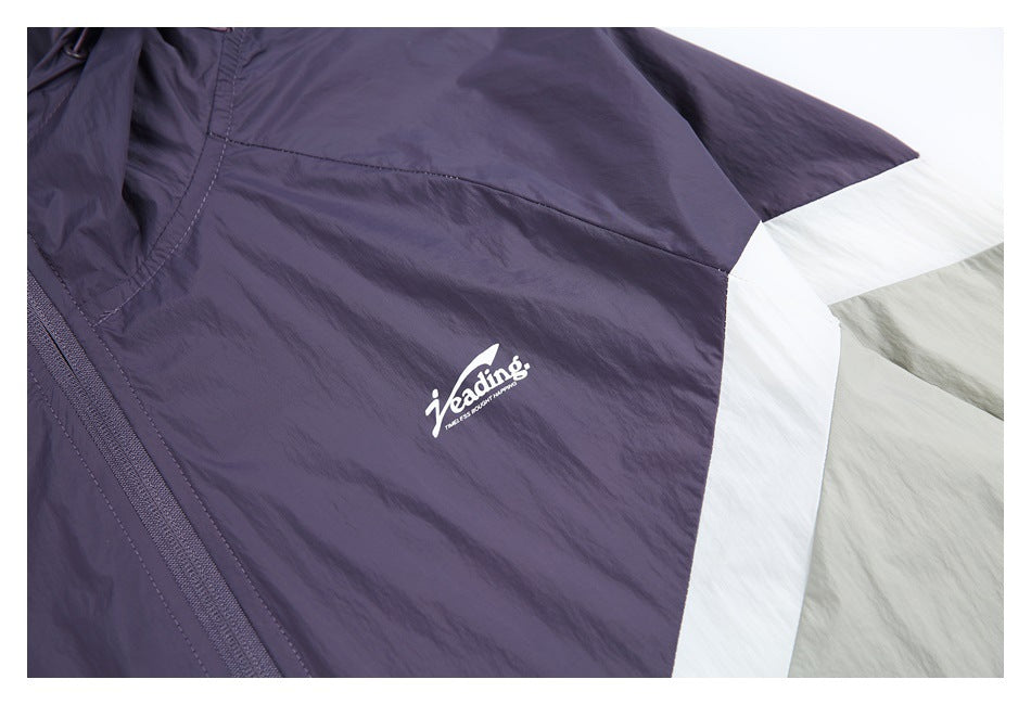Close-up of the purple chest panel with a small white logo beside the white and pale gray sleeve panels.