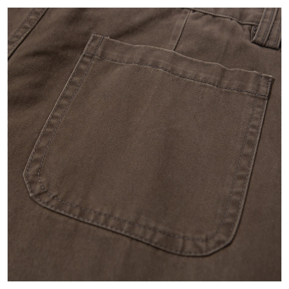 Close-up of a stitched rear pocket on brown pants.