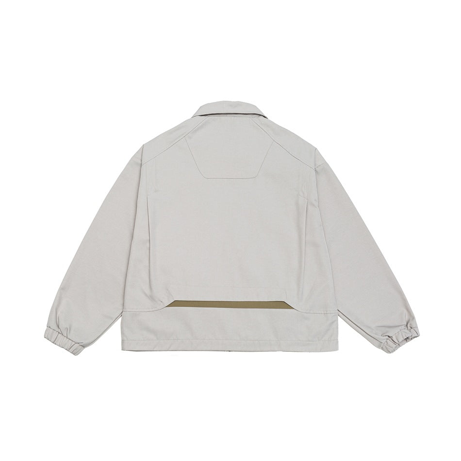 Back view of a light gray cropped jacket with a collar, panel seams, and gathered cuffs.