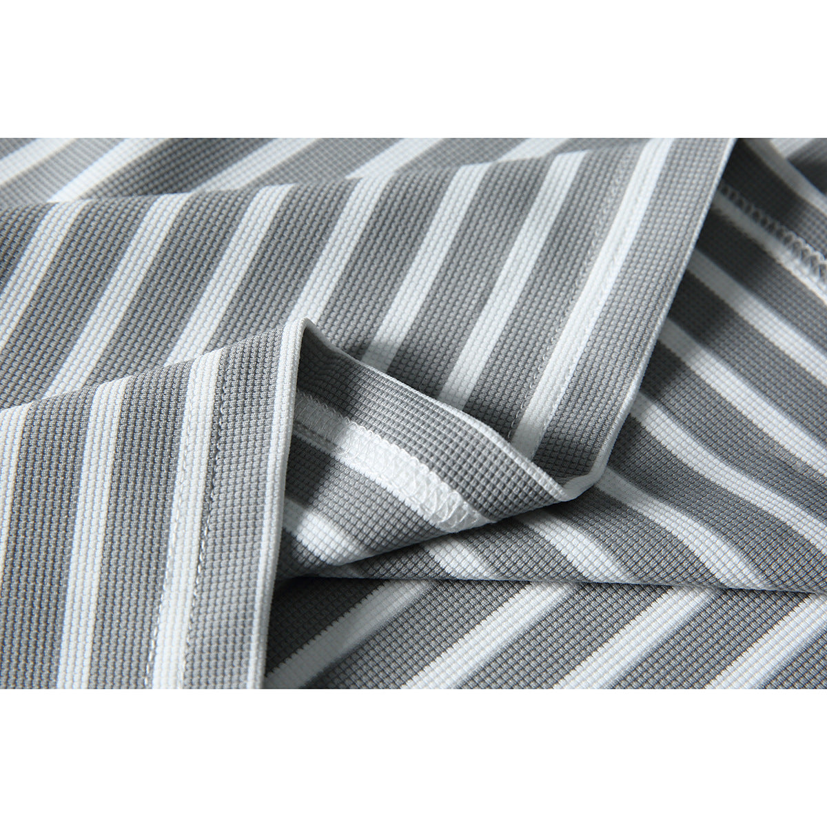 Close-up of gray-and-white striped shirt fabric and stitched seam finishing.