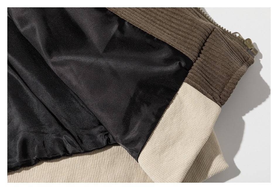 Garment interior showing black lining, a zipper, and brown and cream ribbed sections.