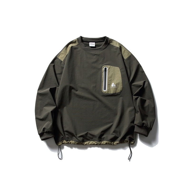 Front view of a dark olive long-sleeve pullover with contrast shoulder panels, a zippered chest pocket, and adjustable hem