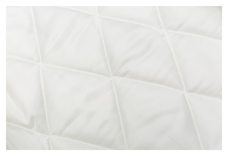 Close-up of white quilted jacket fabric with large diagonal stitched panels.