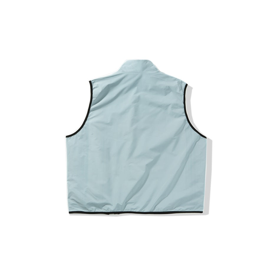 Back view of a pale blue sleeveless vest with a stand collar and black trim around the armholes and hem.