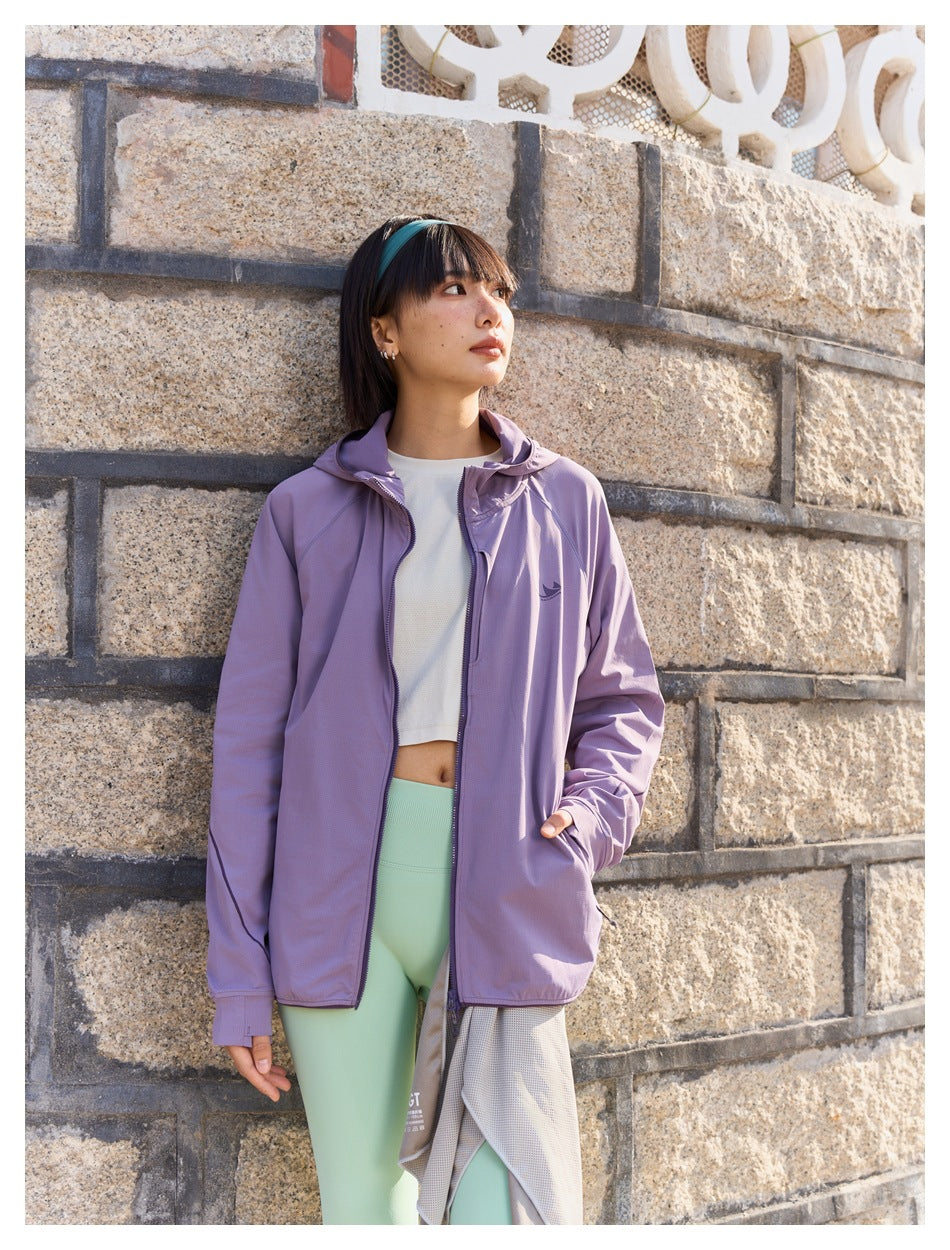 Model wearing a lavender hooded jacket over a white top and mint-green leggings.