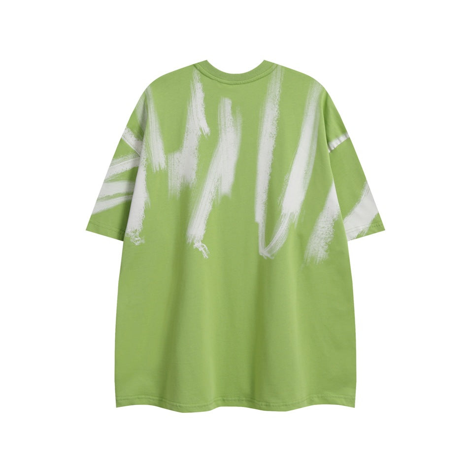 Front view of a loose green T-shirt with large white brushstroke graphics.