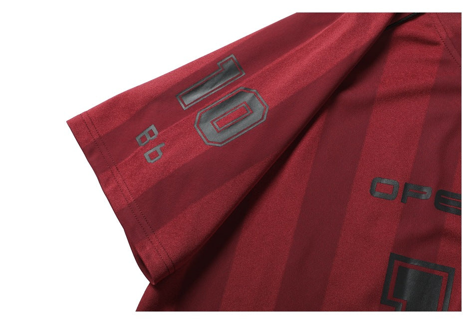 Burgundy striped shirt sleeve and body with dark printed lettering and numerals.