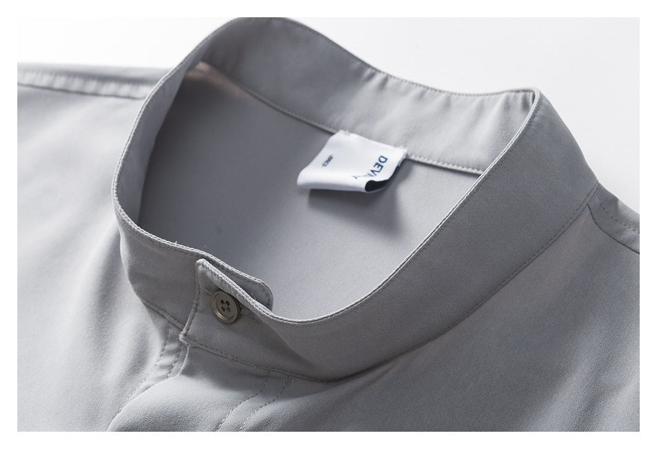 Close-up of the shirt's stand collar, button fastening, and inner neck label.