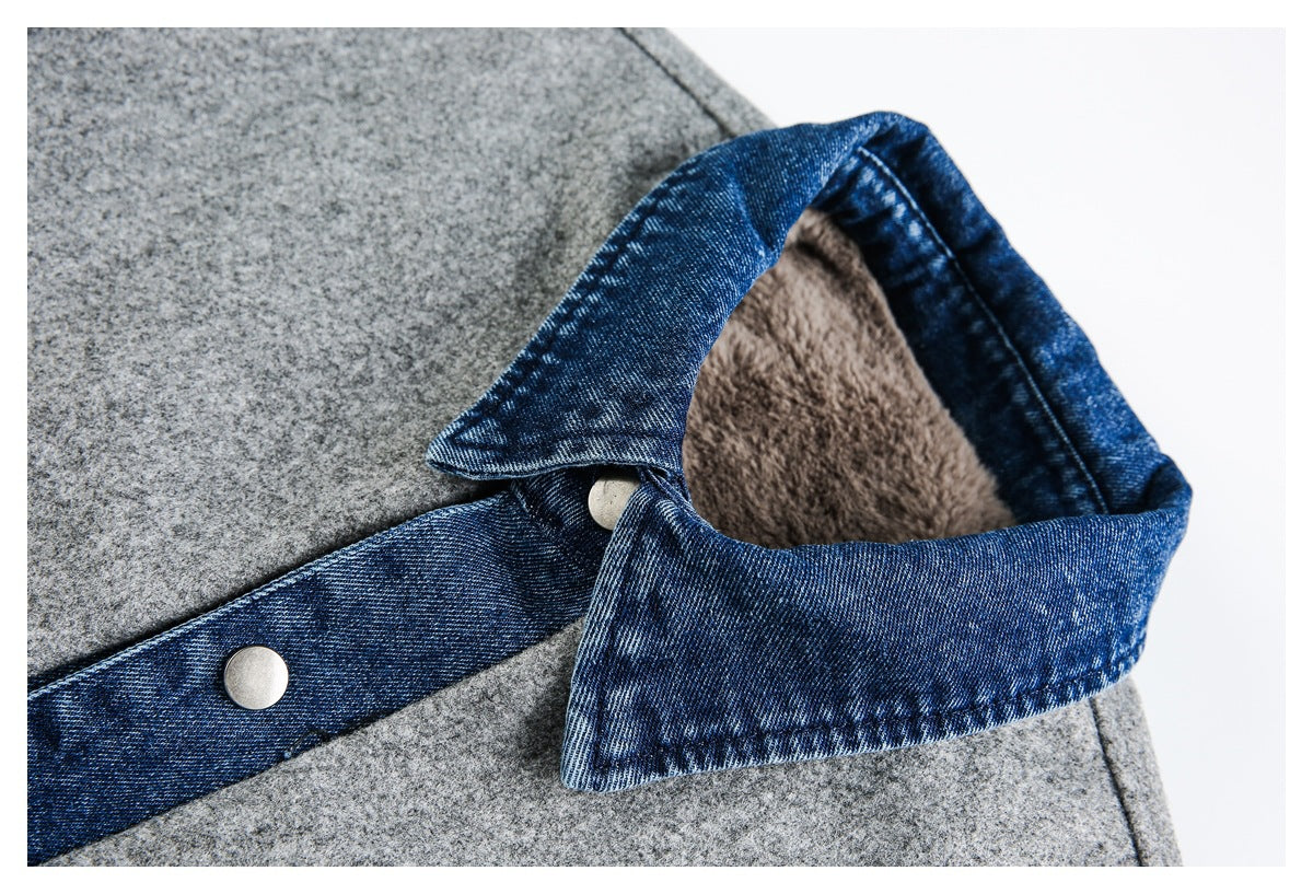 Close-up of a pointed blue denim collar with a snap button on a gray jacket; plush lining is visible inside.