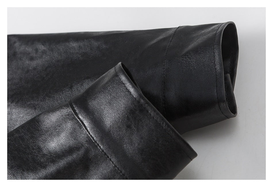 Close-up of a black jacket sleeve and cuff, showing the cuff opening and seam.