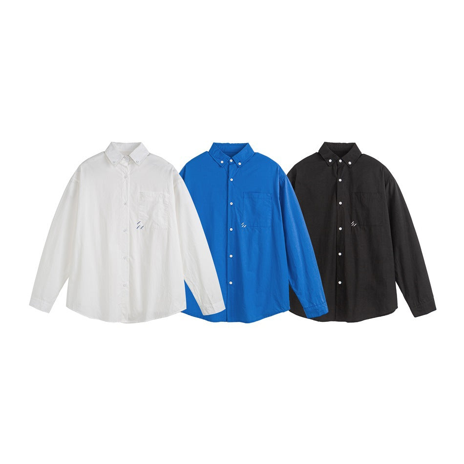 Three button-down shirts displayed together in white, bright blue, and black.